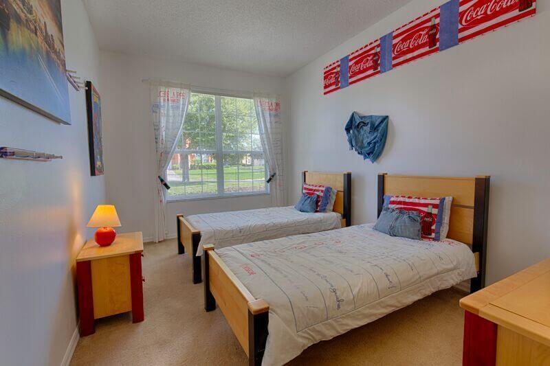 Bedroom #3 with two twin beds and a flat-screen TV