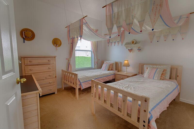 Bedroom #4 with two twin beds and a flat-screen TV