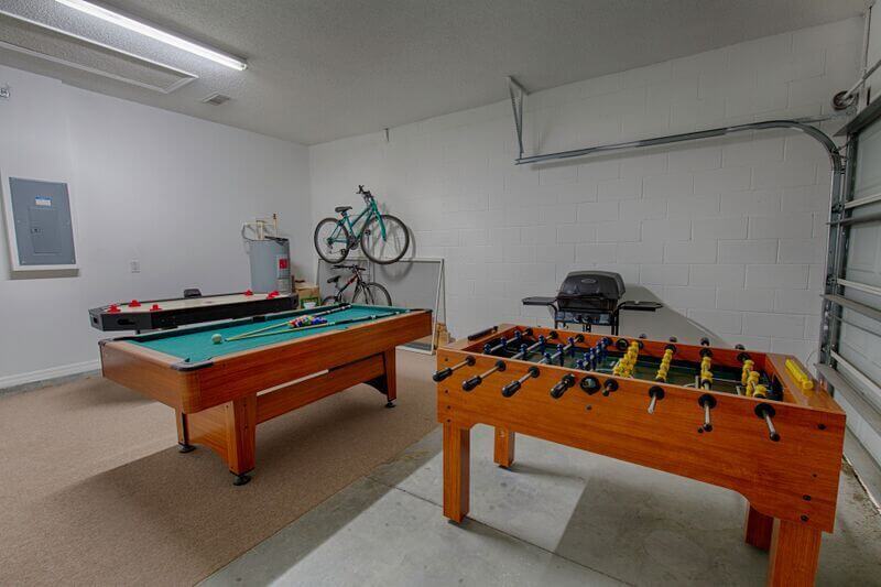 Garage has a pool table and foosball table