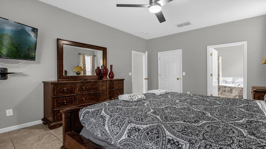 This bedroom has a walk-in closet, en-suite bathroom, and a 50" ROKU SMART TV